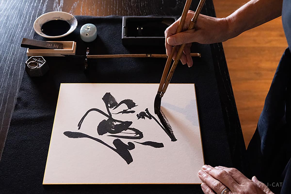 Luxury Experiences in Tokyo Man practicing calligraphy