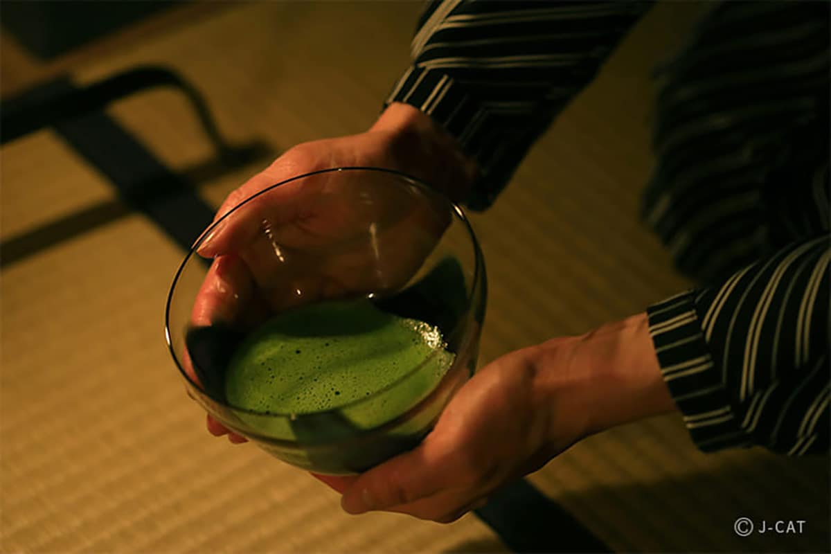 Luxury Experiences in Tokyo Man holding a bowl of green tea
