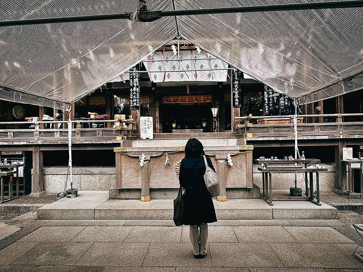 Yamanobe-no-michi Trail Woman saying a prayer at Omiwa Jinja