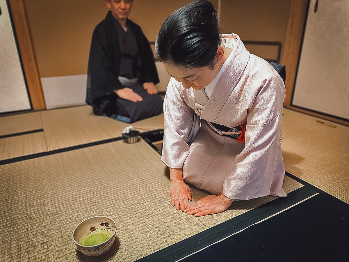 Japanese woman serving green tea