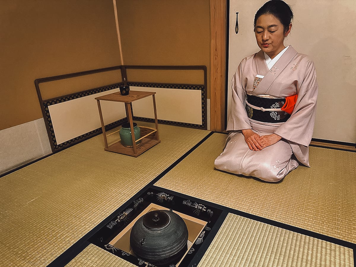 The Japanese Tea Ceremony Japanese woman kneeling in front of a hearth